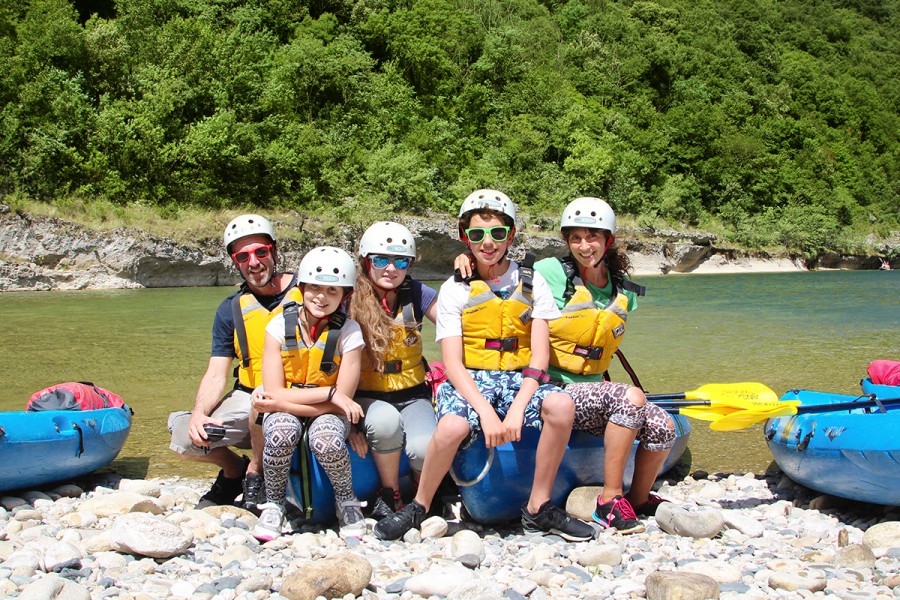 Family sitting on kayak in Ardeche